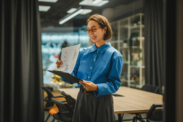 Businesswoman reviewing business charts and data in office meeting room