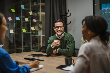 Diverse business professionals having informal meeting in modern office