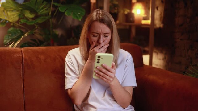 confused woman reacts indoors, indoor scene with anxious woman, woman displays confusion after phone alert in cozy room, woman shows perplexity reacting to message in warm indoor environment