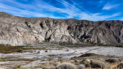 A Pair of Naturalists exploring the Whitewater River in California as the hike through the rocky...