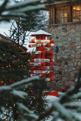 Iconic Red Signpost (Pencil-Shaped) with White Directional Signs to Global Cities in Santa Claus Village, Lapland