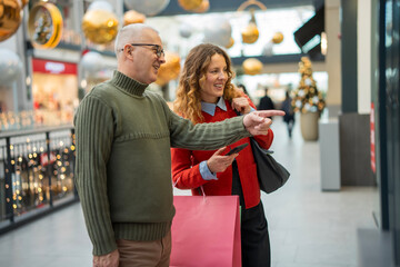 People enjoying shopping pointing at store display