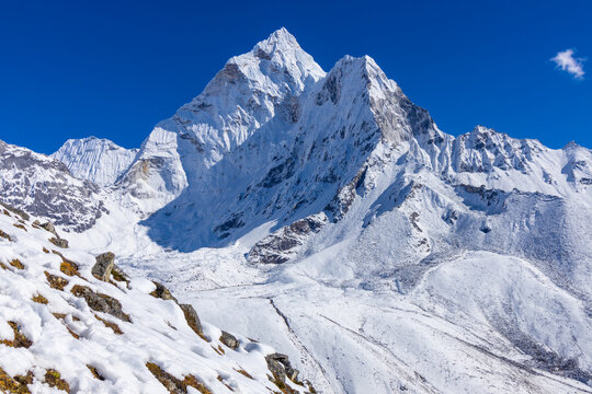Ama Dablam mountain summit, famous mountain view in Himalaya mountains, Nepal. Everest Base Camp trek beautiful landscape view of snow high altitude summit and glacier. AmaDablam classic view
