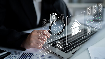 A business professional engaged with laptop technology, utilizing digital icons related to real estate management for efficient workflow and organization. Gantry