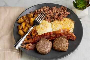 eggs over easy with home fries and corn beef hash
