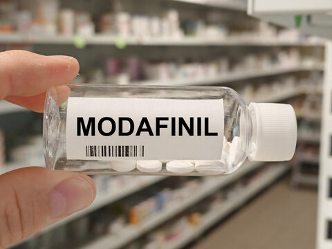 Box of MODAFINIL tablets on a hospital pharmacy table used to treat narcolepsy and sleep disorders a wakefulness promoting agent.