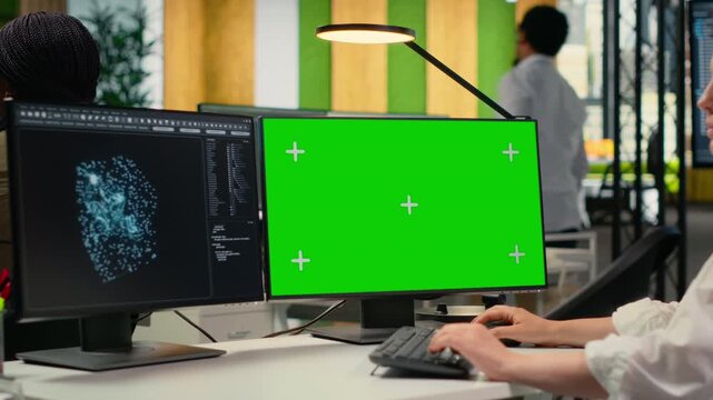 Isolated screen PC AI used by admin in office to optimize company systems performance. Worker in startup office uses artificial intelligence on chroma key computer to automate tasks, camera B