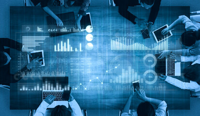 A diverse team engages in data analytics collaboration using laptops and tablets in a modern office, featuring various charts and graphs that enhance their insights. Scalp