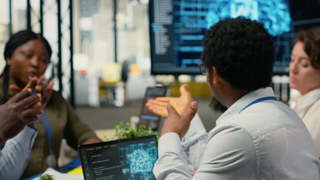 System administrators working in AI startup training predictive models for language processing tasks. Machine learning tech experts use technical expertise for complex IT requirements, camera B