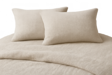 Bed with two cozy beige pillows and soft comforter blanket on transparent background, offering relaxation and comfort