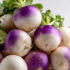 Fresh turnips piled together with crisp white bulbs and vibrant purple tops, captured in bright lighting. Clean composition showcasing organic produce for markets, farming, and healthy food themes. 