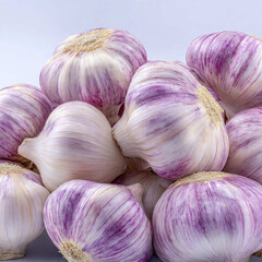 A pile of garlic bulbs with subtle earthy tones and detailed outer layers. Soft lighting creates a natural look, great for farming, markets, cooking tutorials, and ingredient photography.