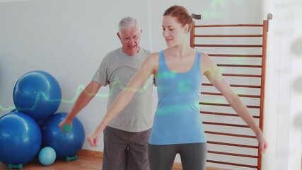 Coach starting arm raises, client copying, aiding shoulder rehab with green weights and ECG overlay