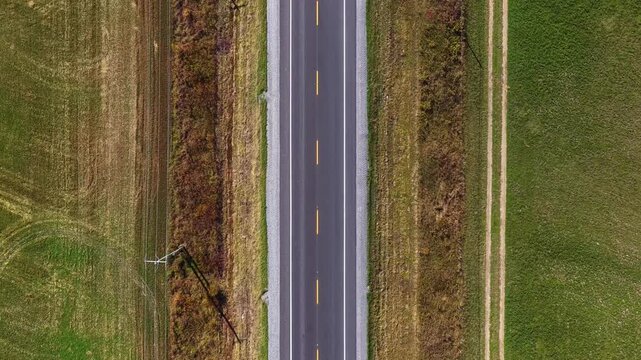 90-degree aerial top view of a road in autumn in the Estrie region of Quebec, Canada. Colorful fall foliage, rural landscape and scenic seasonal nature from above.