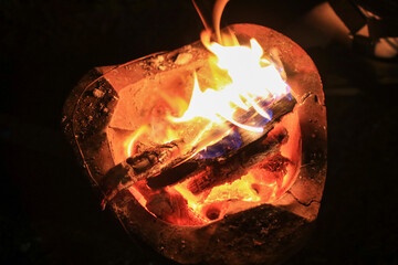 Burning charcoal wood in local stove creating the environment for cooking. Orange hot BBQ fire. 
