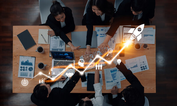 Fototapeta A diverse business team engages in a strategy meeting, focusing on growth and innovation. Visuals of digital analytics and a rocket reflect their ambitious objectives. Trope