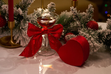 Festive Holiday Cocktail with Red Bow and Heart Gift Box on Christmas Table