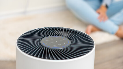 Modern air purifier with sleek design and control panel, enhancing indoor air quality for a...