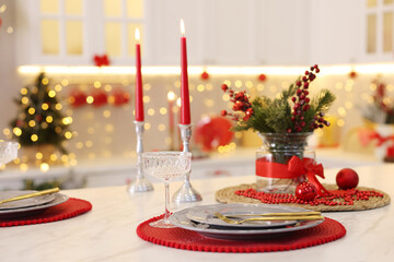 Christmas decor and tableware on white marble table in kitchen. Interior design
