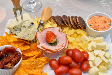 Trays filled with Brazilian sweets: brigadeiro, tortelete, and grape surprise, along with savory snacks with tomatoes.