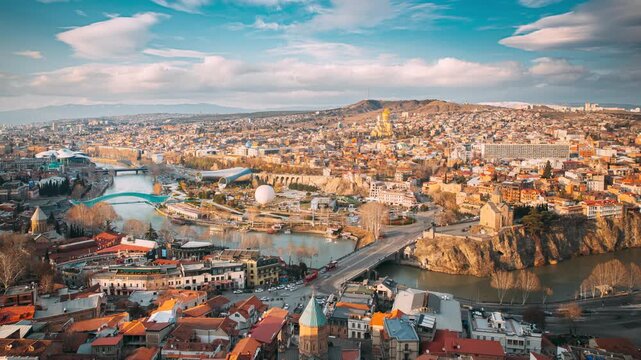 Tbilisi, Georgia. Top View Of Famous Landmarks In spring sunset Evening. Georgian Capital Skyline Cityscape. Justice House, Bridge Of Peace, Concert Hall, Rike Park And Presidential Palace, Metekhi