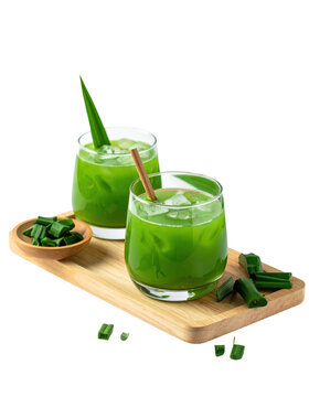 Creamy buko pandan dessert drink with coconut jelly cubes and shreds, presented in a clear serving glass, isolated on white background