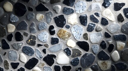 Close up view reveals a textured surface composed of embedded, polished stones in varied cool tones.