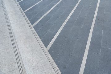 Fototapeta premium Modern Granite Staircase and Tiled Ground Texture. architecture, urban design, modernity, and safety.