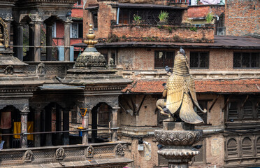 Fototapeta premium Rear view of the Garuda statue sitting on stone pillar in Patan Durbar Square, Nepal. Patan Durbar Square is one of three Durbar Squares in Kathmandu, Nepal.
