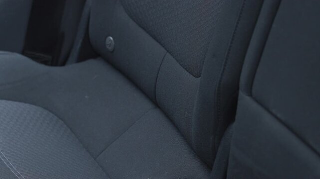 Raising rear car seat backrest in modern SUV interior with clear latch sound