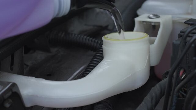 Car windshield washer fluid pouring into plastic reservoir in engine bay with detailed water pouring sound, close up automotive service