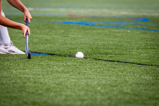 Field hockey player about to strike the ball