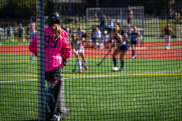 FIeld hockey goalie watches the play