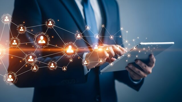 Business professional using a tablet with a digital network connecting global communications - Powered by Adobe