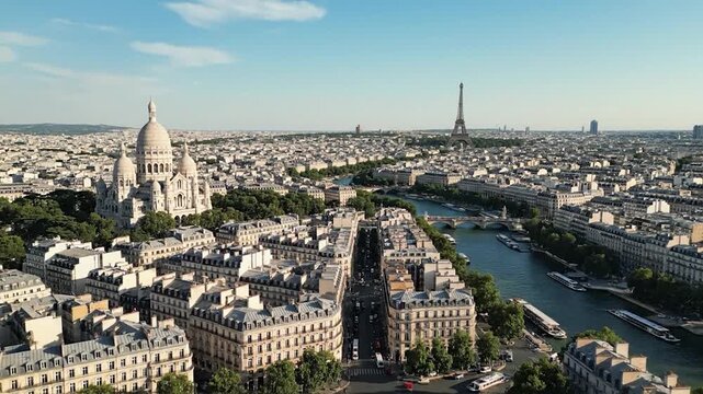 Aerial view of a city with the Eiffel Tower in the distance, a river, and architectural structures