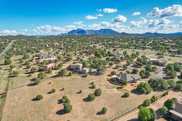 An empty field with trees and a bright blue sky background