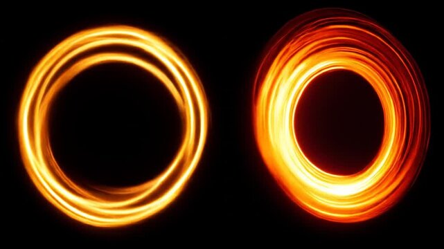 Two bright, glowing, ring-shaped forms with a black background, emitting radiant energy