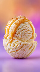 Single scoop of vanilla ice cream with caramel drizzle and nuts on colorful gradient background