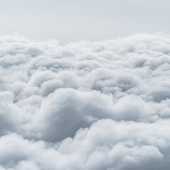 White clouds dancing on pastel blue sky creating tranquil and atmospheric scene, fluffy light grey cumulus clouds for powdery, soft effect in shades of white, overcast weather
