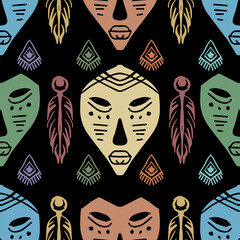 Ethnic seamless pattern with tribal mask and feathers on black background. Vector illustration.