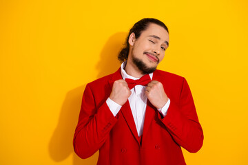 Funny cool red suit man with bowtie strikes a cheerful pose in bright yellow backdrop for fashion and style themed stock image showman vibe