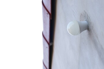 White Light Bulb Installed on Exterior Wall of Building with Minimalistic Background