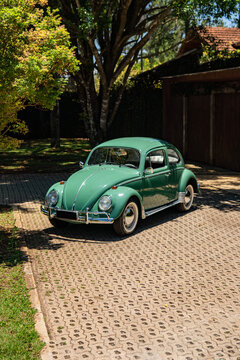 Green Volkswagen Beetle high angle view, Classic vintage sedan parked on pavement