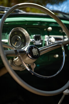 Volkswagen Beetle steering wheel close up, Vintage car interior with Wolfsburg crest detail
