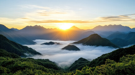 Soft misty mountains sunrise over valley with sea of fog and golden sunlight
