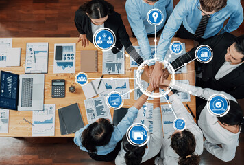 A diverse group of professionals engages in a collaborative meeting, using graphs and icons to represent strategic ideas and goals for effective business development. Amity