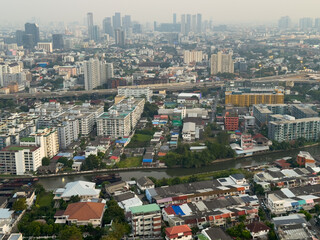 Naklejka premium 13 December 2025 colourful sunset with fluffy white pink purple orange and blue skies over the city towers of BKK Bangkok Thai Thailand