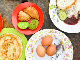 Traditional Malaysian Breakfast Assortment on Colorful Plates