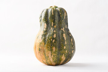 Ripe, yellow-green butternut squash after autumn harvest from an organic farm, on a white background. A healthy cooking ingredient