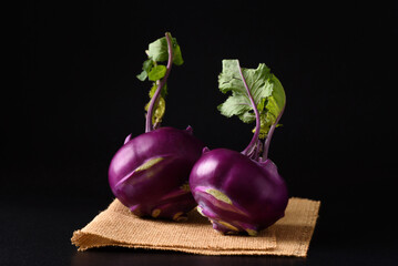 Ripe purple kohlrabi, freshly harvested from an organic farm, placed on a black background, is a healthy ingredient for cooking